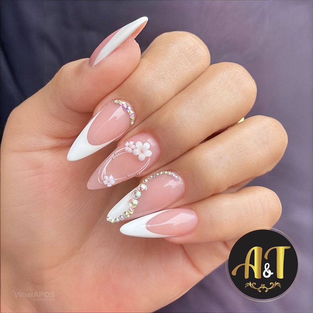 Almond French tip nails with pearl and rhinestone accents by A & T Nails Spa